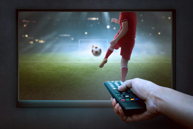 Watching football on a big screen with a remote control